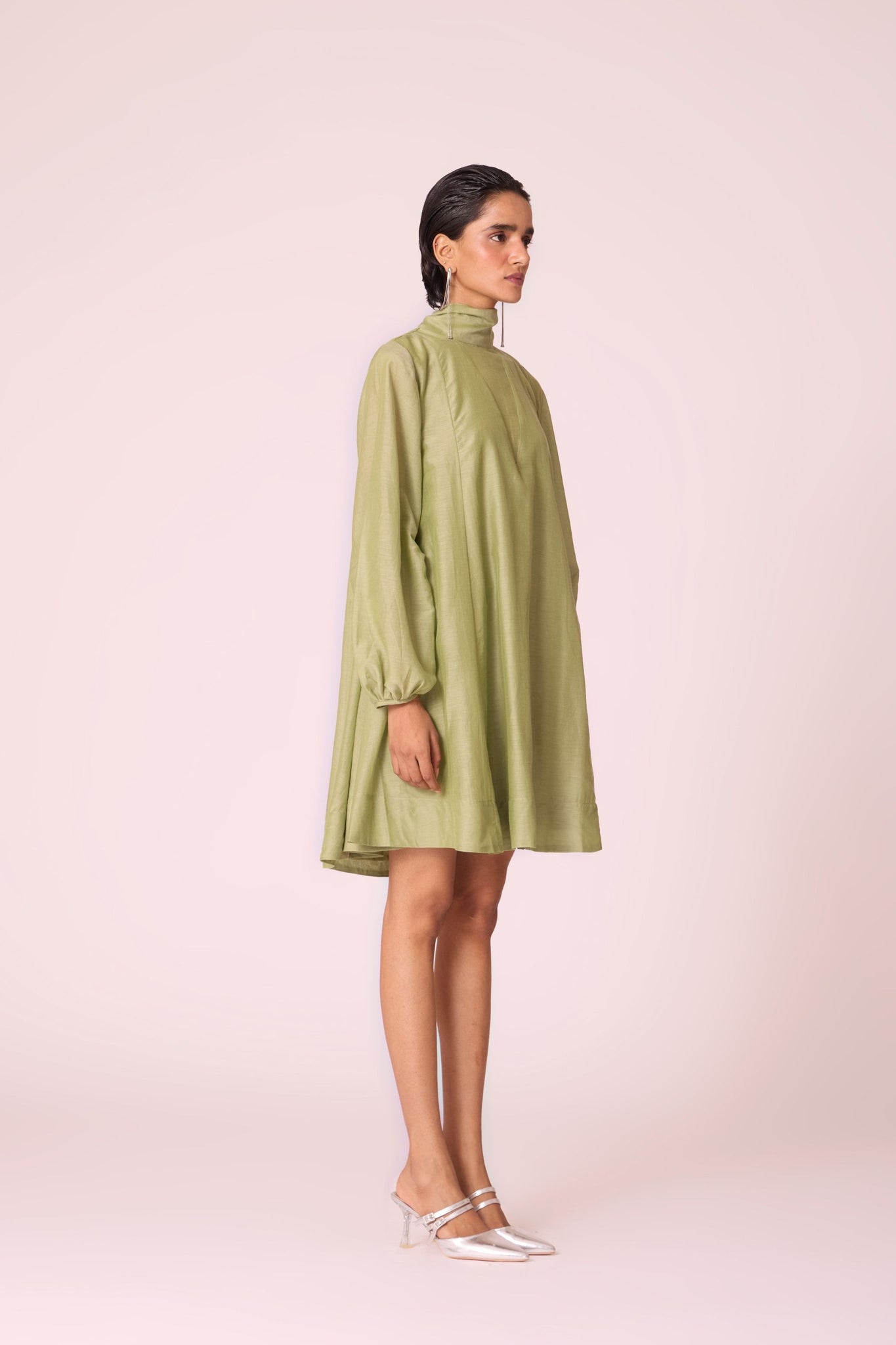 Green silk-cotton panelled short dress with halter neck, back tie, bishop sleeves, and lined body.