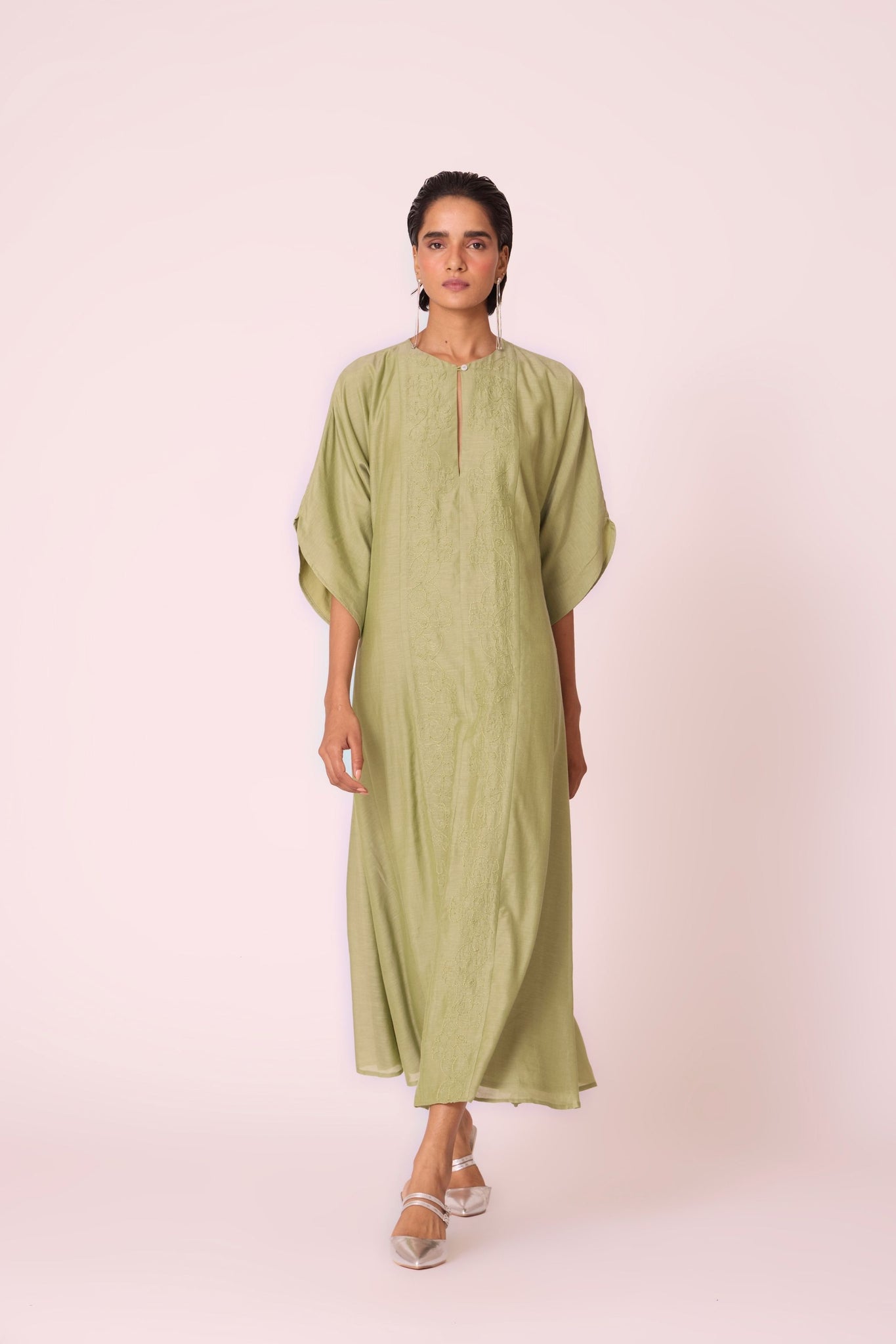 Green silk-cotton dress with hand-embroidered keyhole neckline, drop sleeves, full lining, and in-seam pockets.