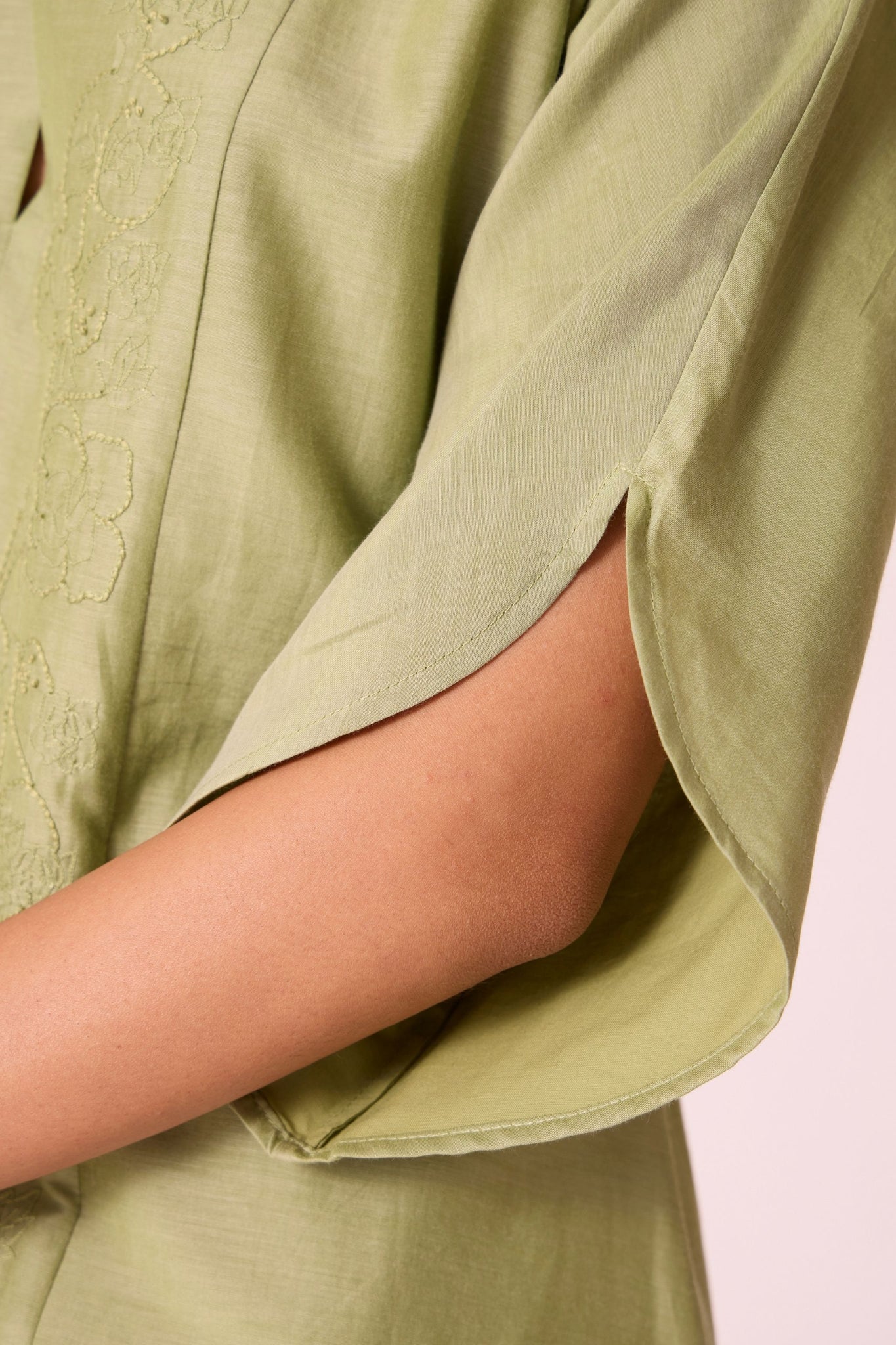 Green silk-cotton dress with hand-embroidered keyhole neckline, drop sleeves, full lining, and in-seam pockets.