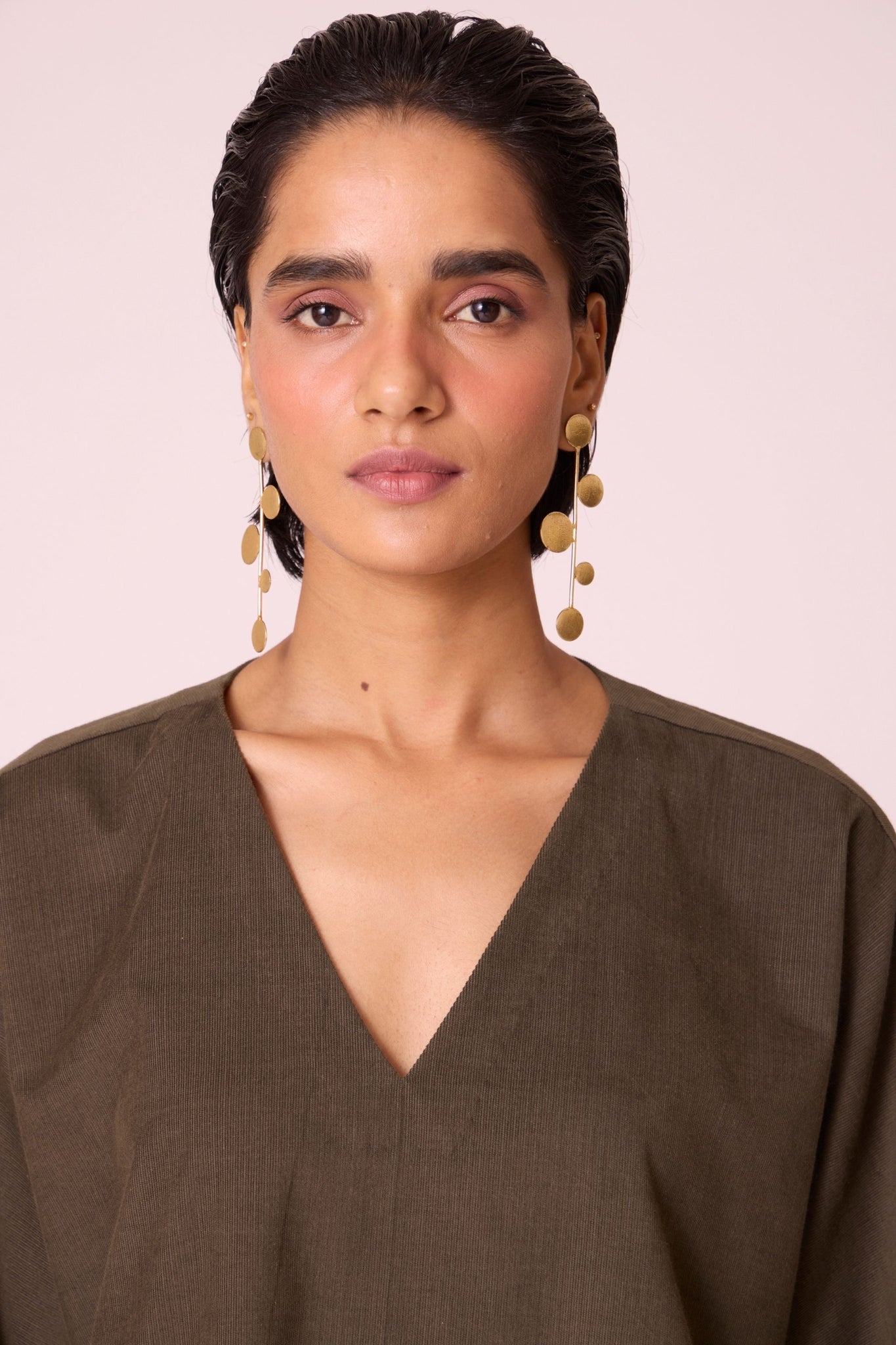 Olive needlecord shift dress with V-neckline, kimono-inspired sleeves, and in-seam pockets.