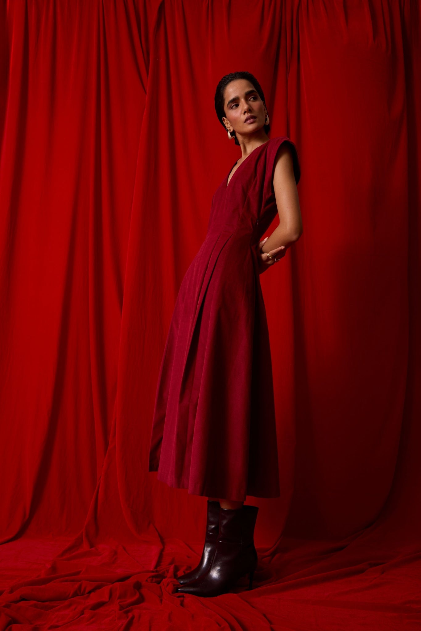 Rust needlecord panelled dress with box pleats, structured drop shoulder, V-neckline, side zip, and in-seam pockets.