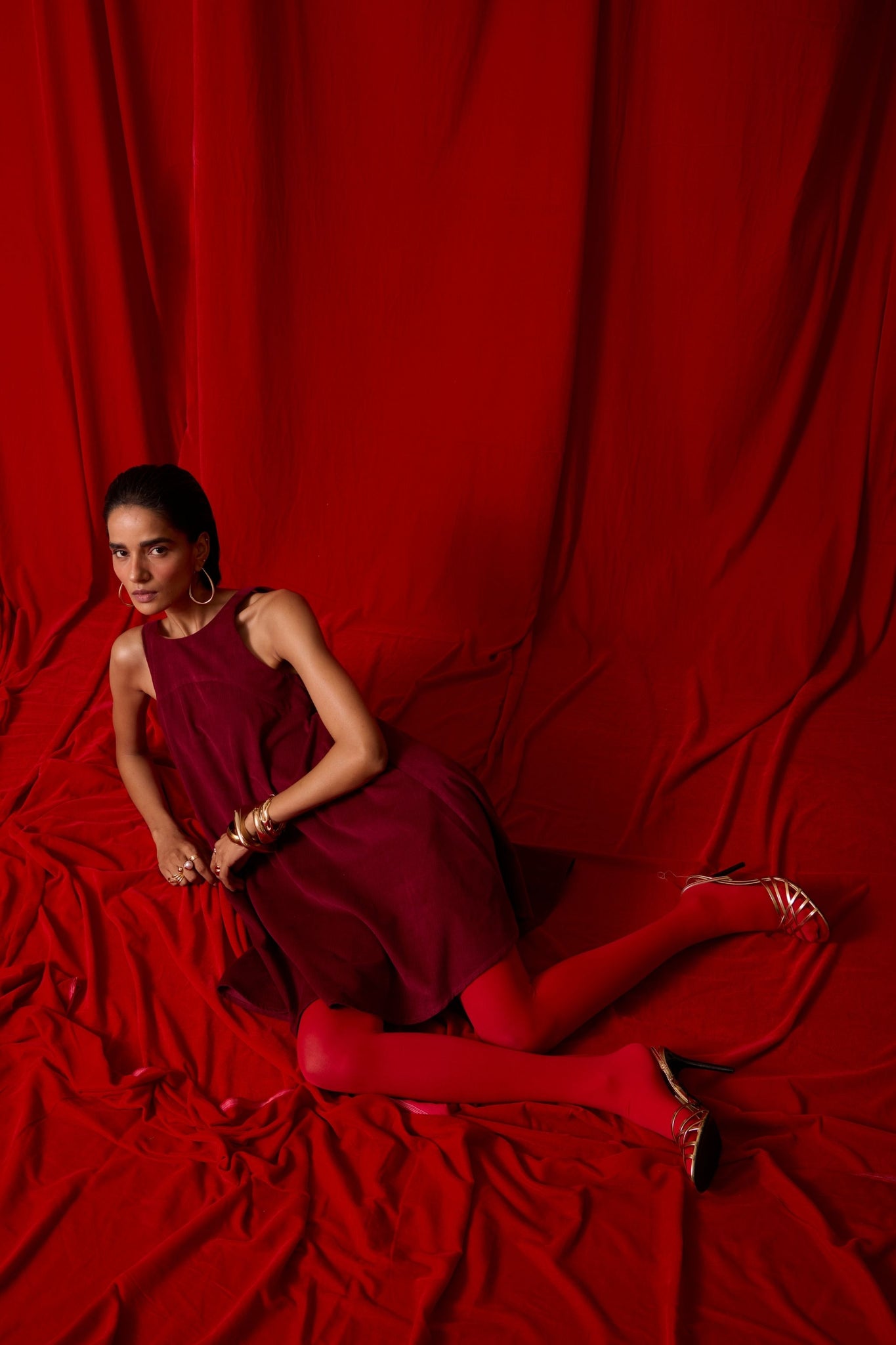 Cherry needlecord tent dress with incut shoulder, low scoop back, and in-seam pockets.
