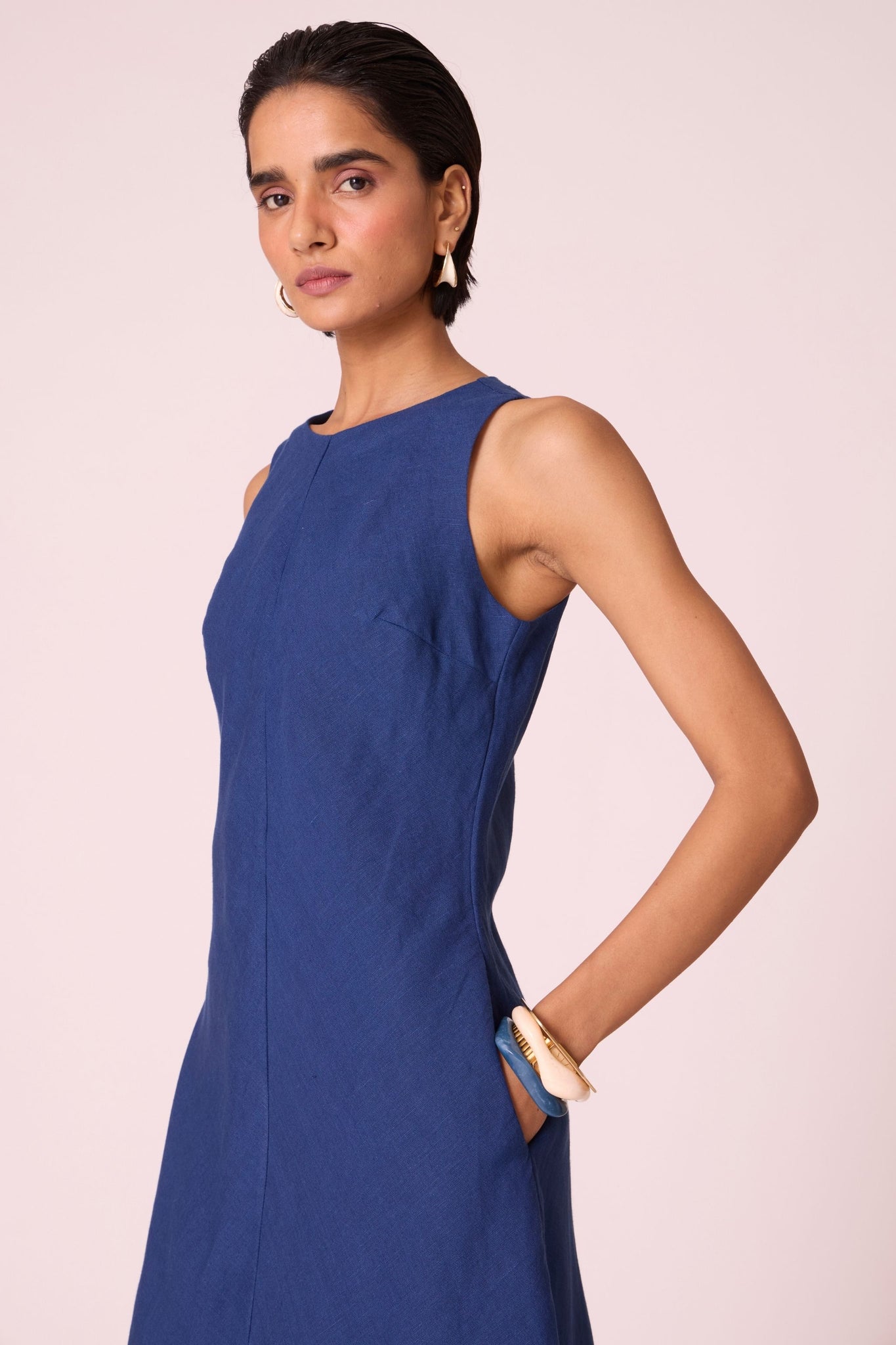Ink blue linen midi dress with high neckline, cutaway sleeves, back zip, full lining, and in-seam pockets.