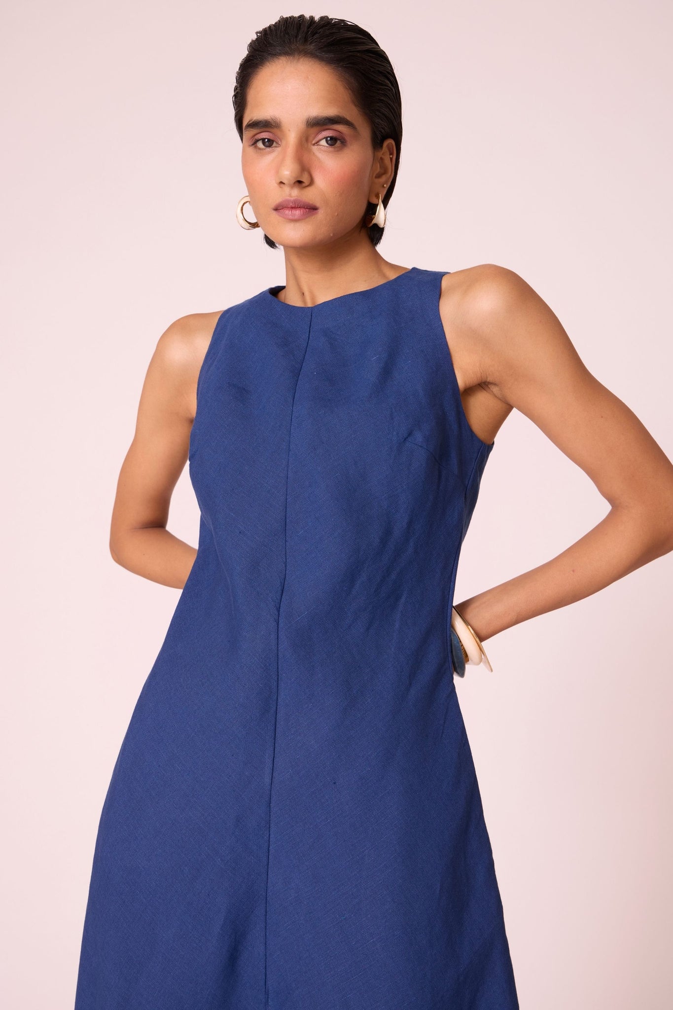 Ink blue linen midi dress with high neckline, cutaway sleeves, back zip, full lining, and in-seam pockets.