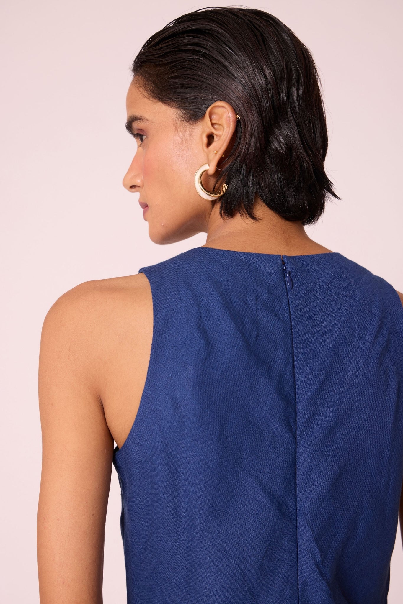 Ink blue linen midi dress with high neckline, cutaway sleeves, back zip, full lining, and in-seam pockets.