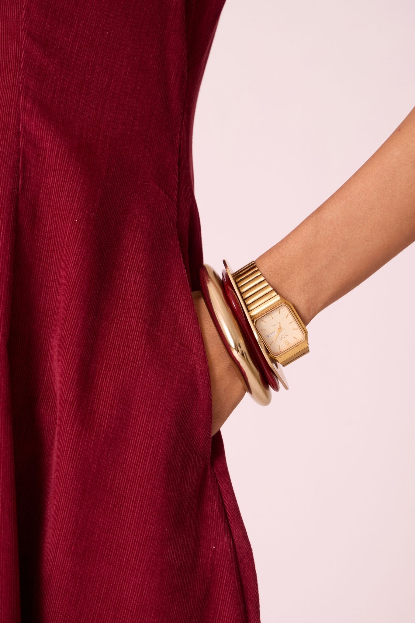 Cherry needlecord fit-and-flare midi dress with soft V-neckline, panel detailing, side zip, and in-seam pockets.
