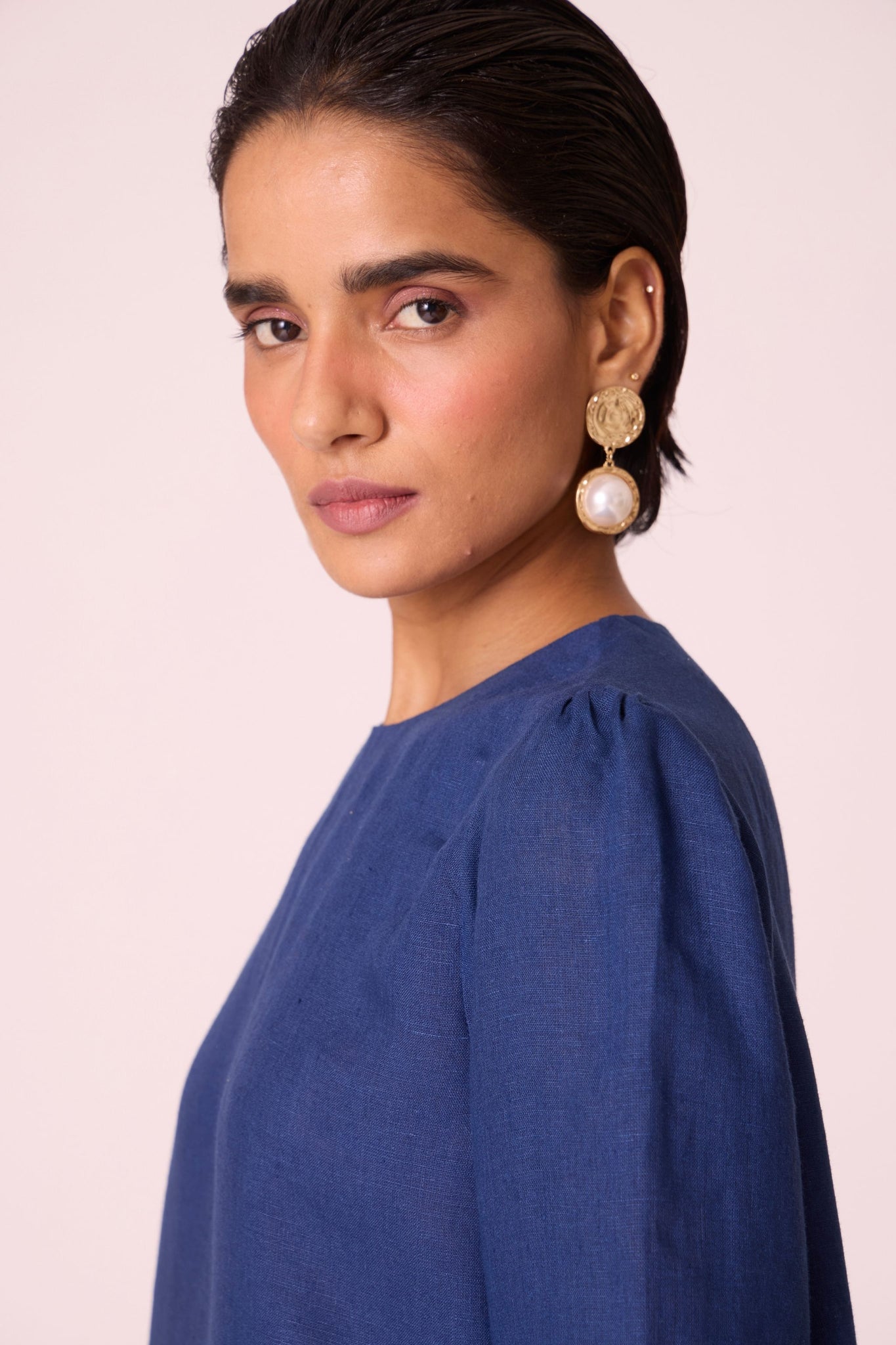 Ink blue linen tunic set with hand-embroidered 3/4 sleeves, back button tunic, and slim-fit side-zip pants.