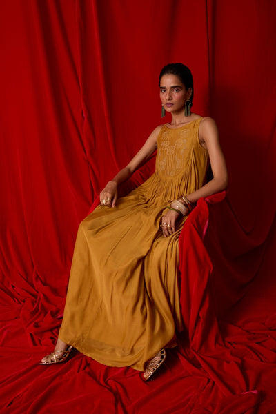Yellow cupro maxi dress with hand-embroidered yoke, low scoop back with elastic strap, full lining, and light waist gathers.

