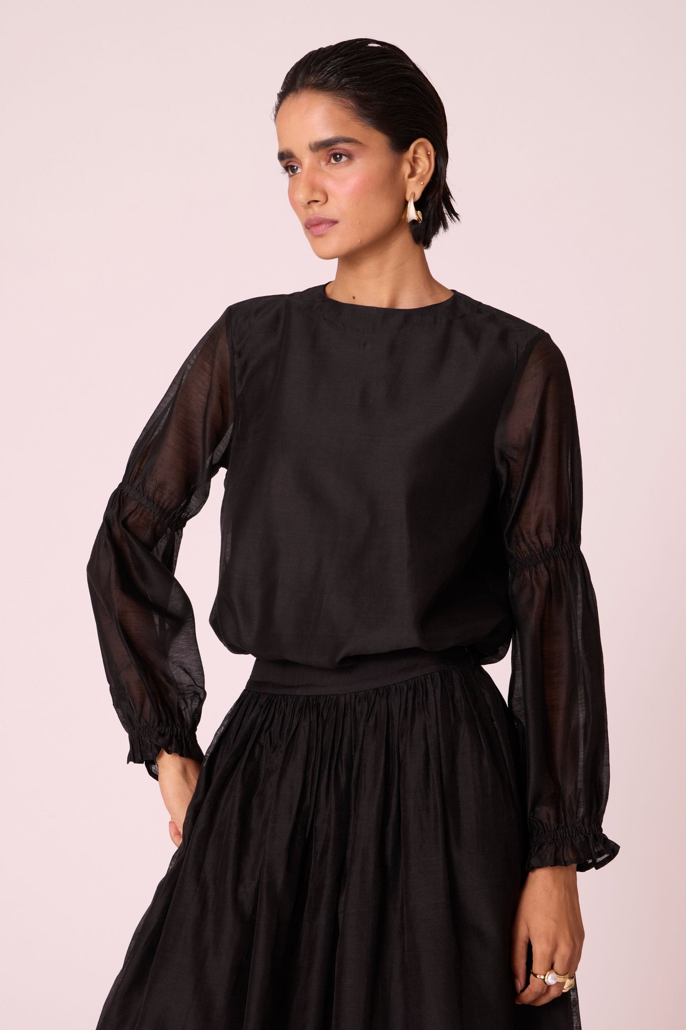 Black handwoven Chanderi top with drawstring waist, back button fastening, and elasticated sleeve details.