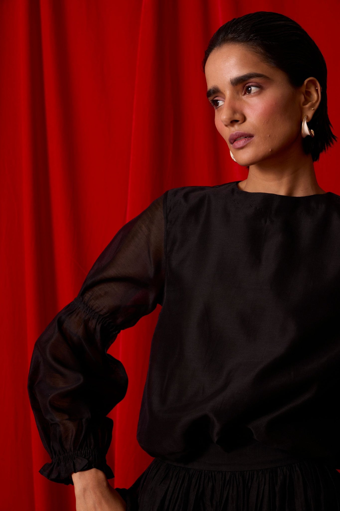 Black handwoven Chanderi top with drawstring waist, back button fastening, and elasticated sleeve details.