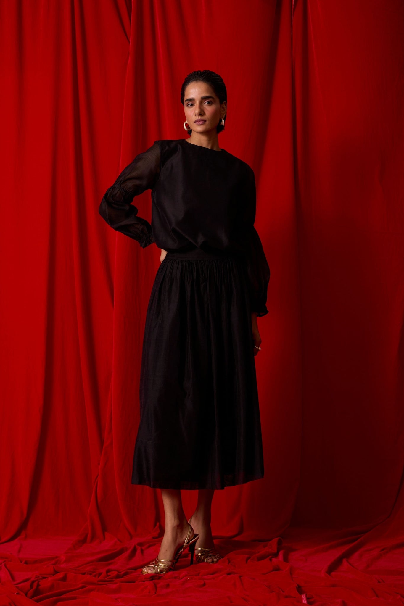 Black handwoven Chanderi top with drawstring waist, back button fastening, and elasticated sleeve details.