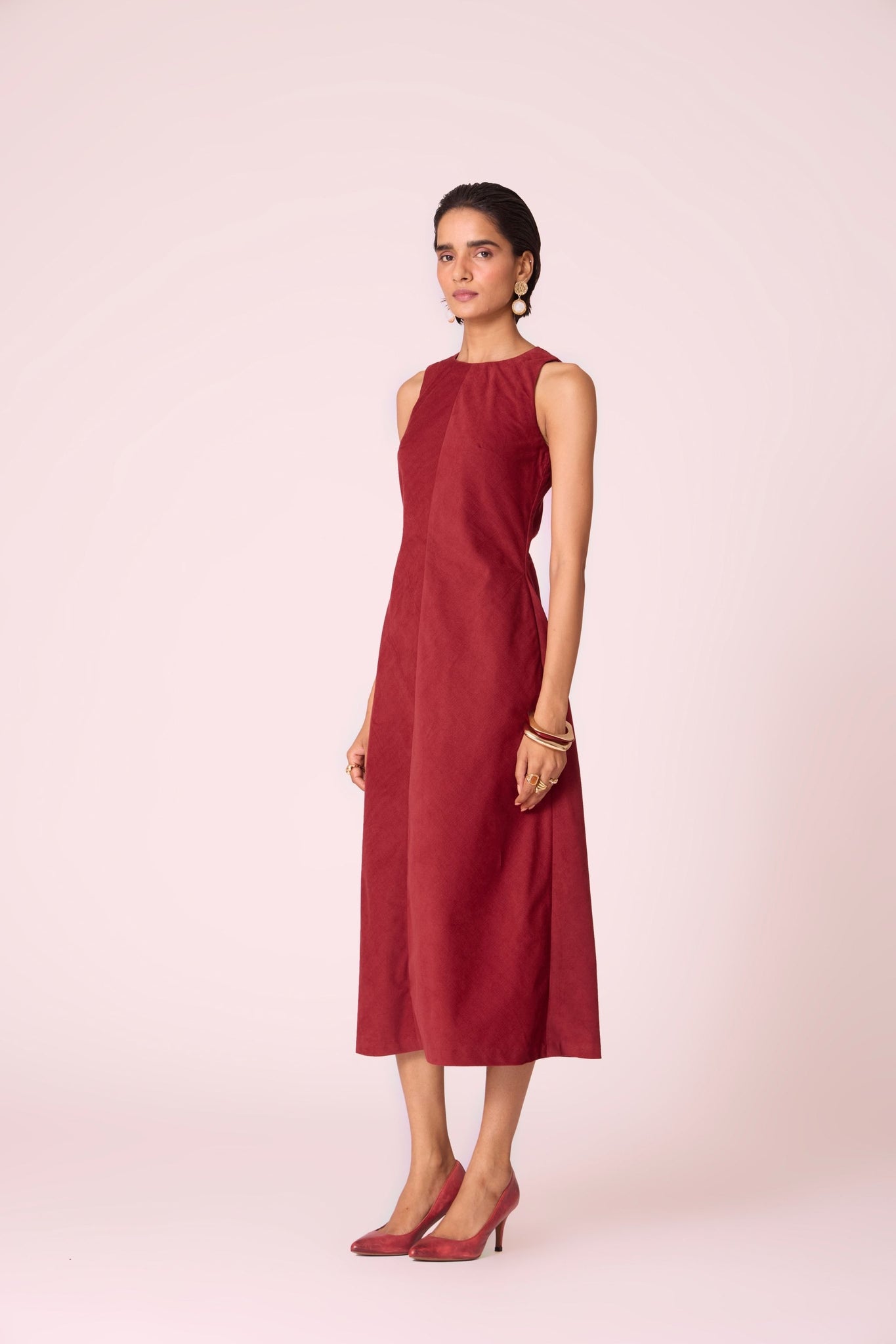 Rust needlecord midi dress with fitted bodice, back slit, back zip fastening, and in-seam pockets.