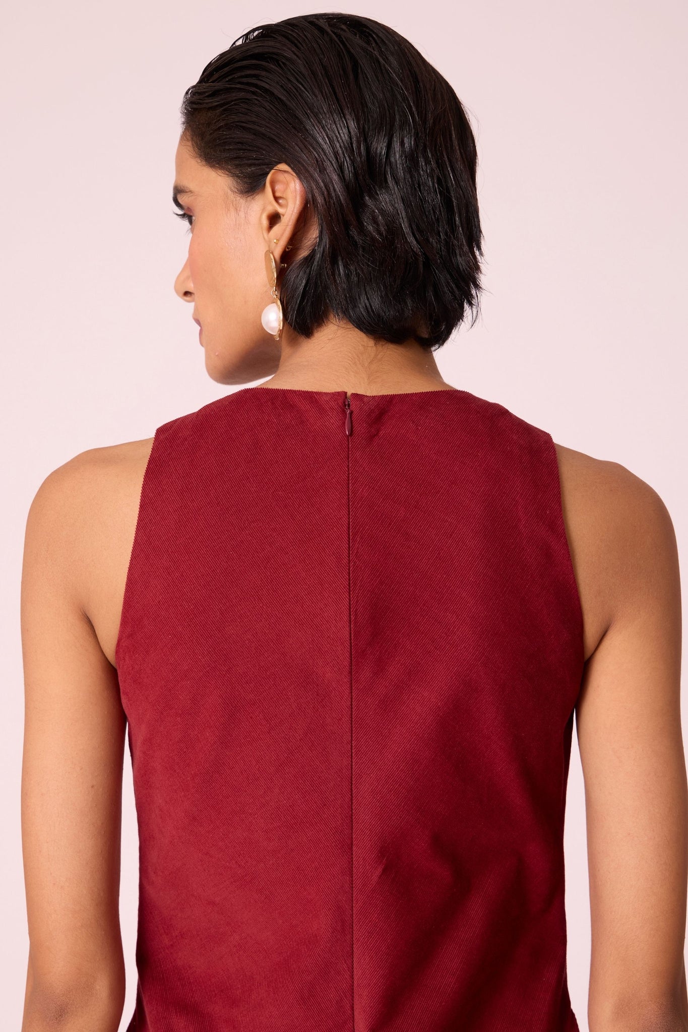 Rust needlecord midi dress with fitted bodice, back slit, back zip fastening, and in-seam pockets.