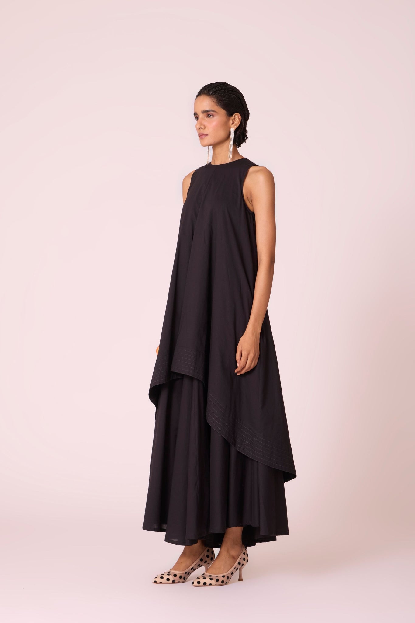 Black layered maxi dress in organic cotton cambric with in-cut shoulders and rouleau back fastening.
