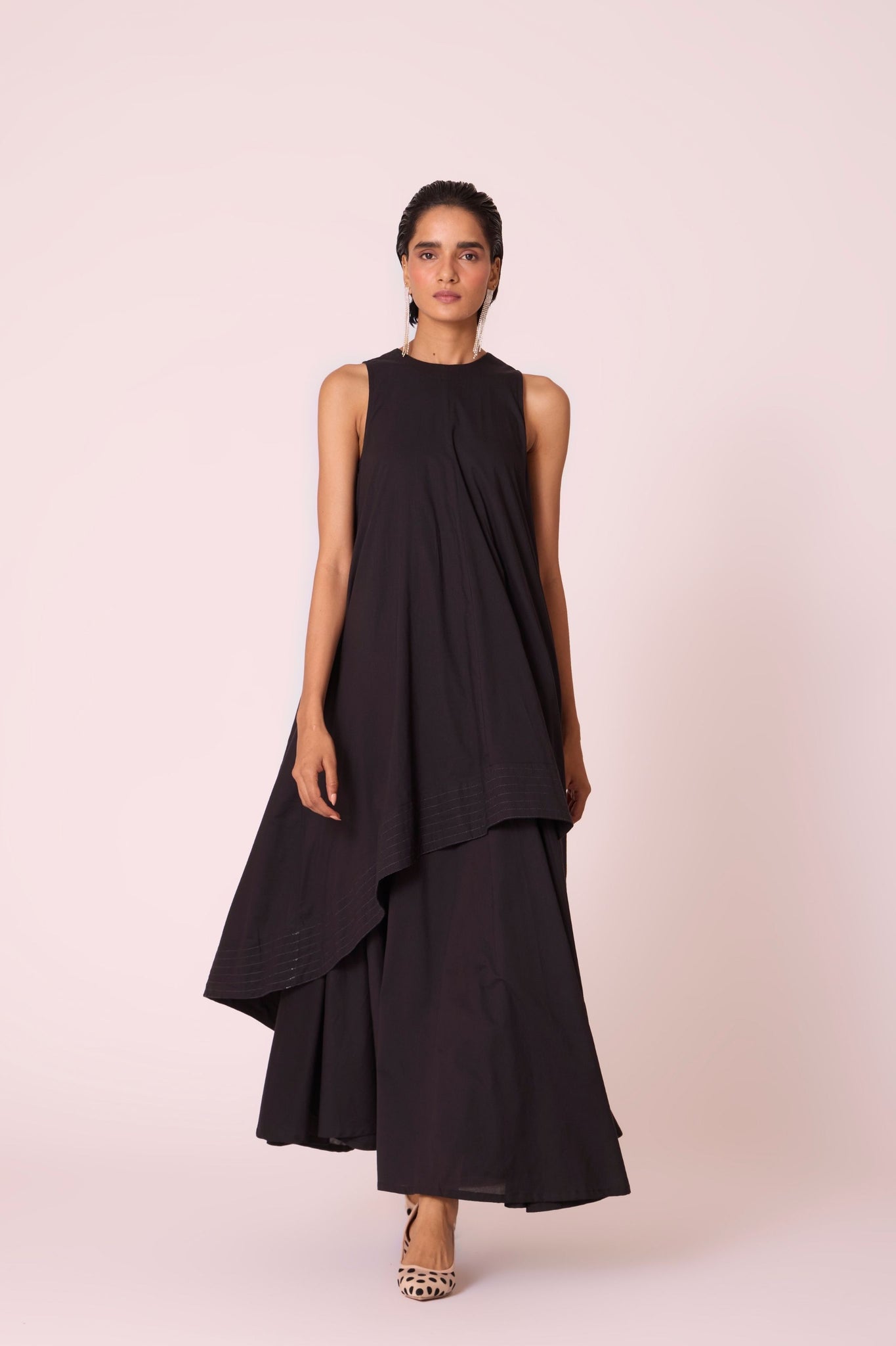 Black layered maxi dress in organic cotton cambric with in-cut shoulders and rouleau back fastening.
