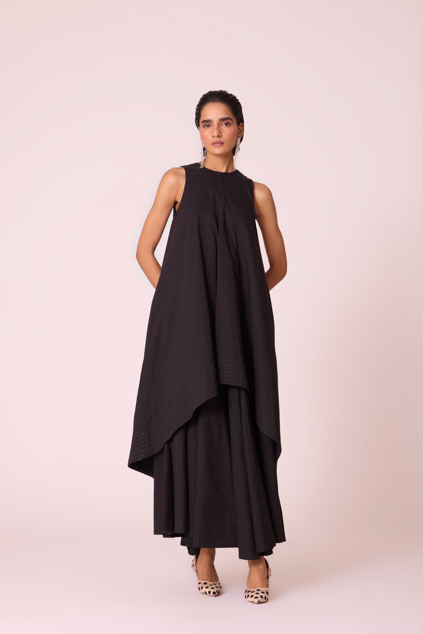 Black layered maxi dress in organic cotton cambric with in-cut shoulders and rouleau back fastening.
