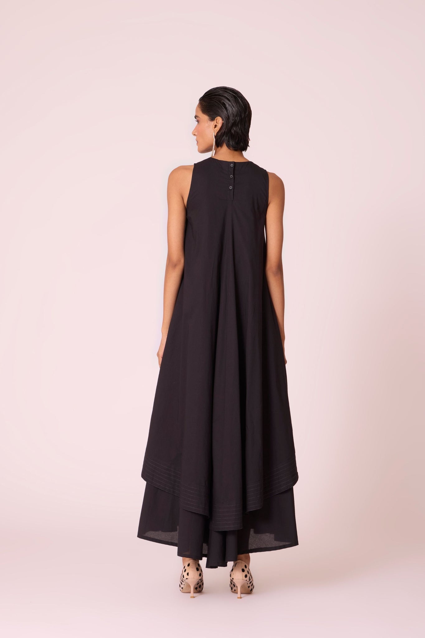 Black layered maxi dress in organic cotton cambric with in-cut shoulders and rouleau back fastening.
