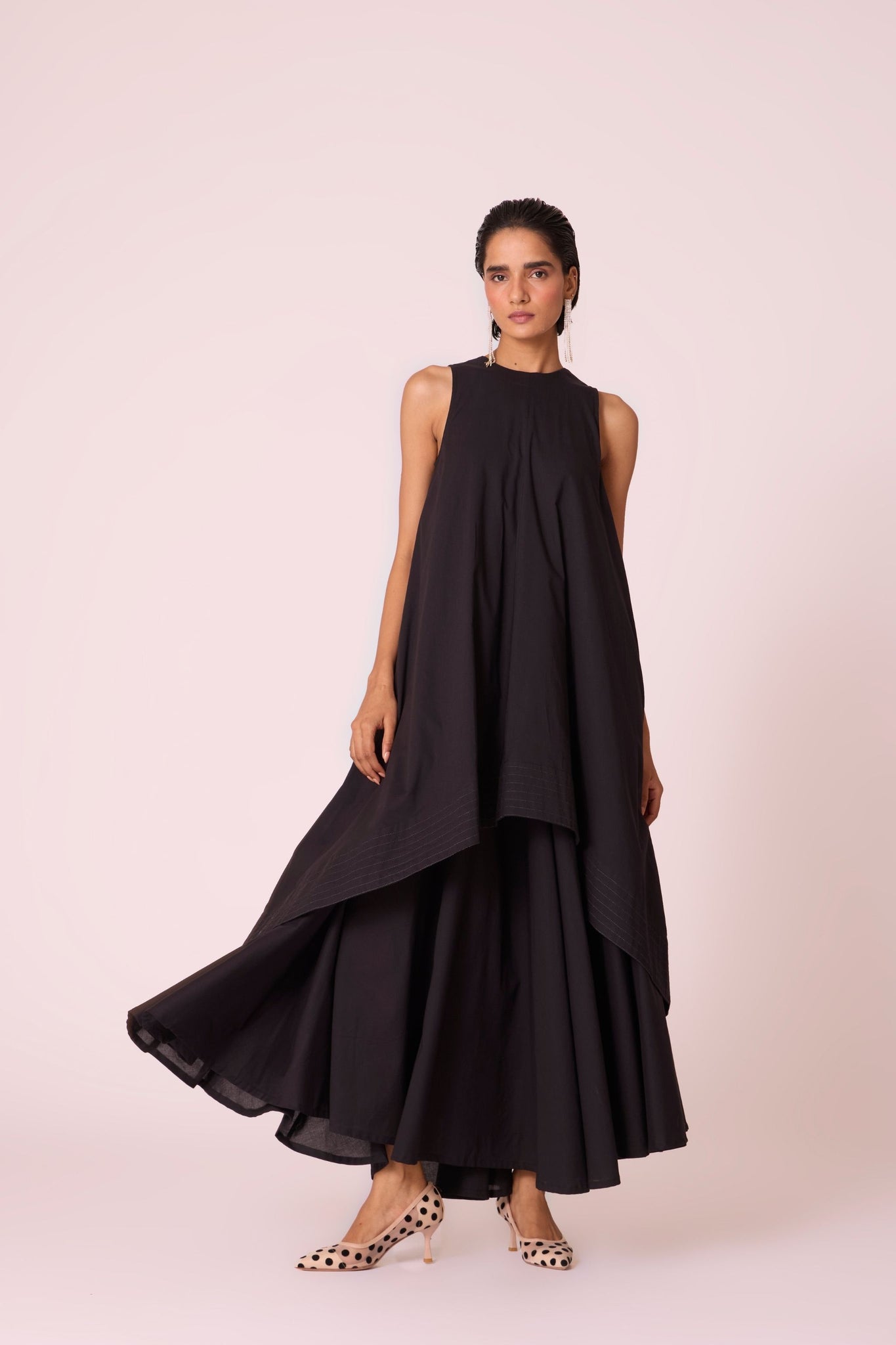 Black layered maxi dress in organic cotton cambric with in-cut shoulders and rouleau back fastening.
