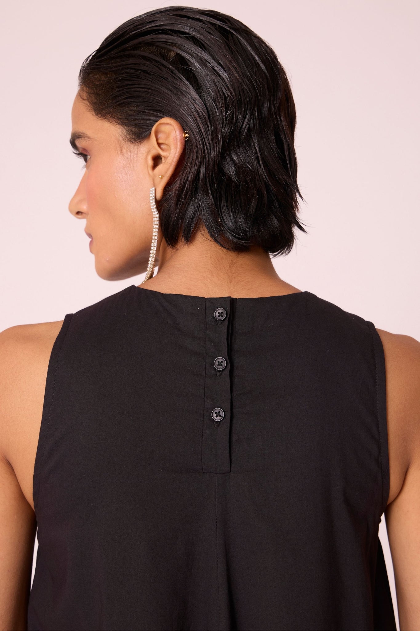 Black layered maxi dress in organic cotton cambric with in-cut shoulders and rouleau back fastening.
