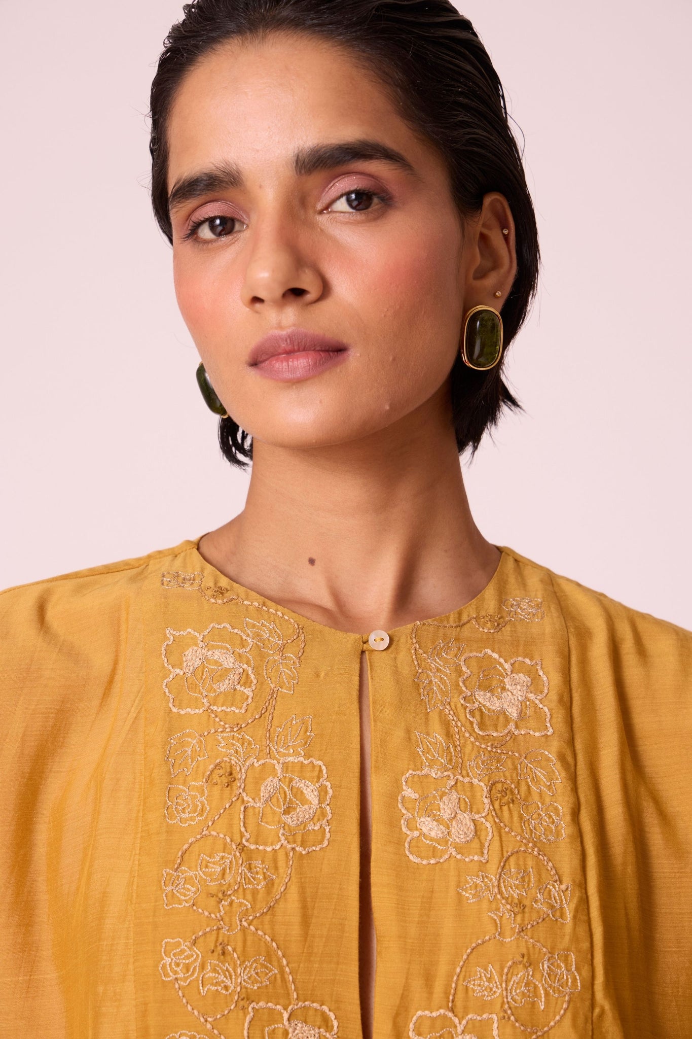 Yellow cupro dress with hand-embroidered keyhole neckline, drop sleeves, full lining, and in-seam pockets.
