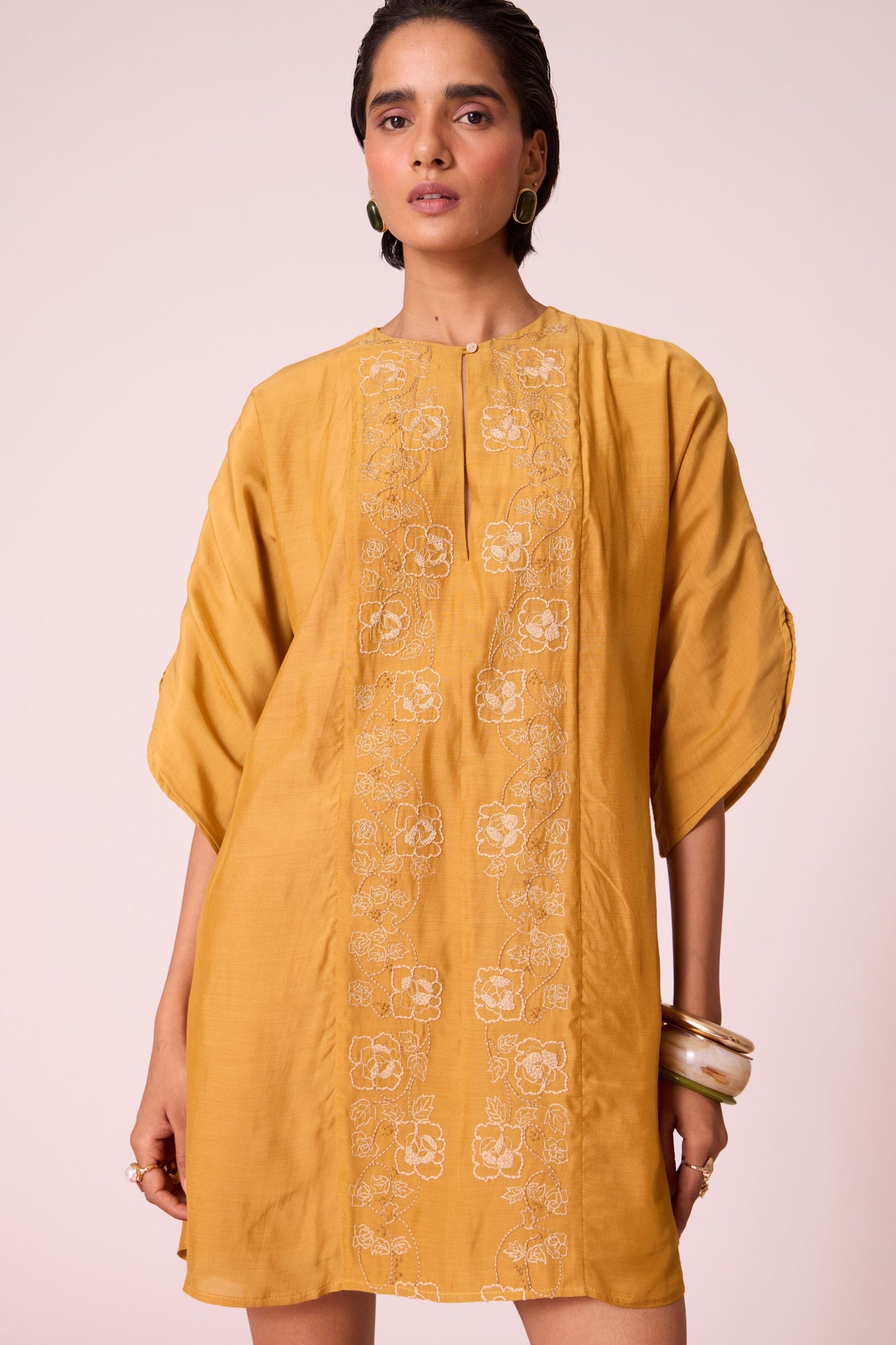 Yellow cupro dress with hand-embroidered keyhole neckline, drop sleeves, full lining, and in-seam pockets.
