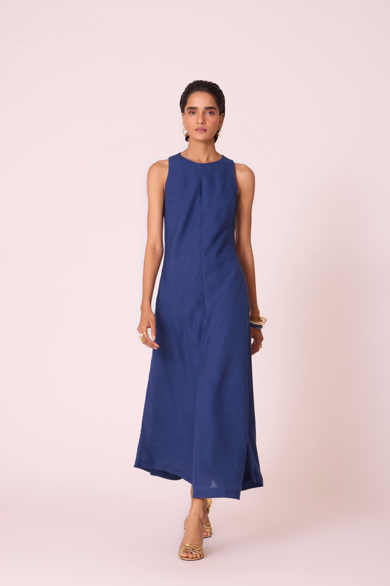 Ink blue linen midi dress with high neckline, cutaway sleeves, back zip, full lining, and in-seam pockets.