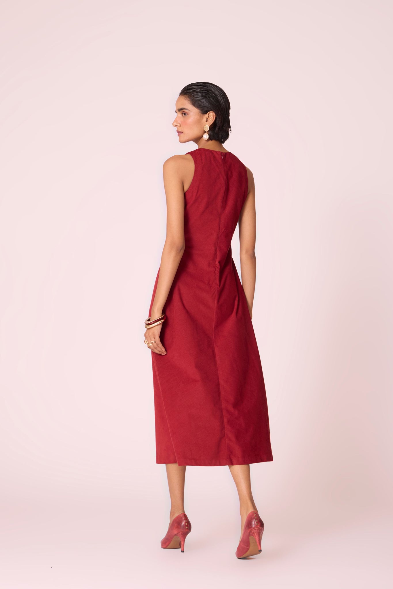 Rust needlecord midi dress with fitted bodice, back slit, back zip fastening, and in-seam pockets.